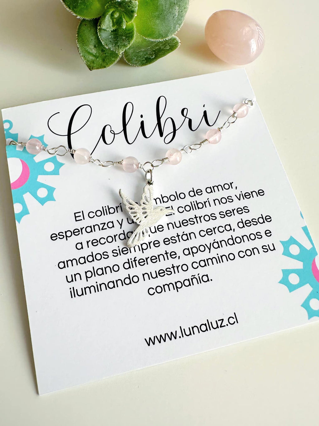pulsera plata  de cuarzo rosa y colibri sobre tarjeta con el significado del colibri